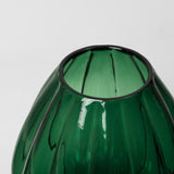 Close-up detail of Broste Copenhagen Malou green glass vase on a light gray background