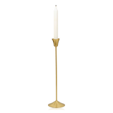A medium-sized slim brass Ria candle holder from Broste Copenhagen with a single white taper candle, shown against a plain white background.