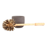Iris Hantverk toilet brush with wooden handle and natural bristles, and grey concrete container on a white background