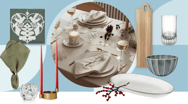Scandinavian Christmas table setting with natural materials, candles and Nordic tableware