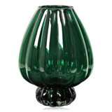 A ribbed, dark green mouthblown glass vase from Broste Copenhagen with a fluted pedestal base, shown on a clean white background.