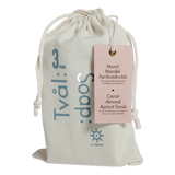 Drawstring bag with 'Tvälå soap' branding and a product tag for carrot, almond, apricot scrub.