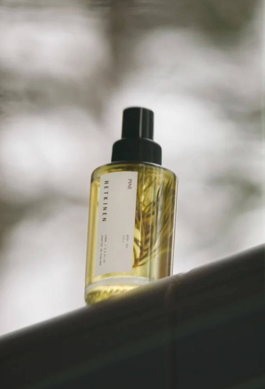 Glass bottle of pine scented body oil by Finnish fragrance house Hetkinen 