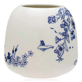 Reverse of white ceramic vase with blue floral patterns on a white background