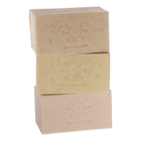 Stack of 3 carrot, almond and apricot kernel soap bars by Iris Hantverk on a white background
