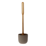 Iris Hantverk toilet brush with wooden handle and natural bristles inside a grey concrete container on a white background