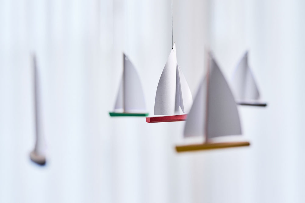 Flensted Mobiles regatta mobile from The Scandinavian Shop features model yachts with brightly coloured hulls