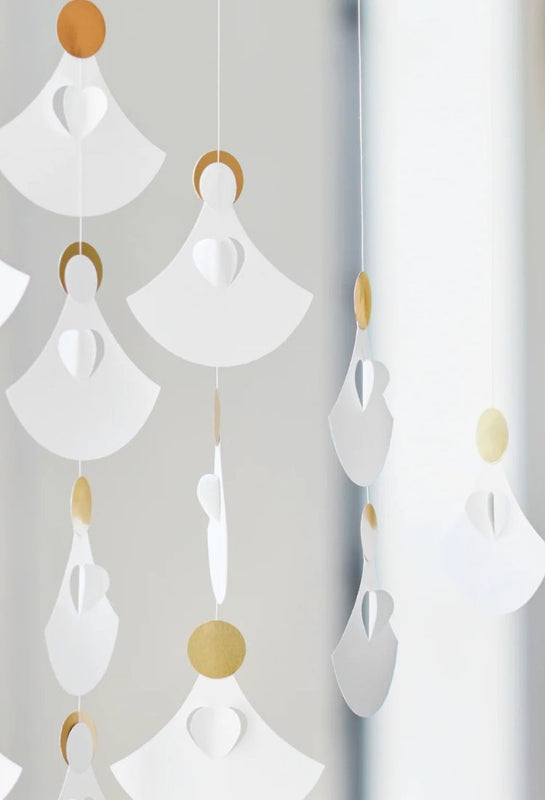 Detail of decorative hanging Flensted angel choir mobile with white and gold elements on a light gray background, available from The Scandinavian Shop