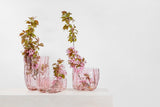 group of three Crackle Vases and bowl by Kosta Boda on table with pink flowers